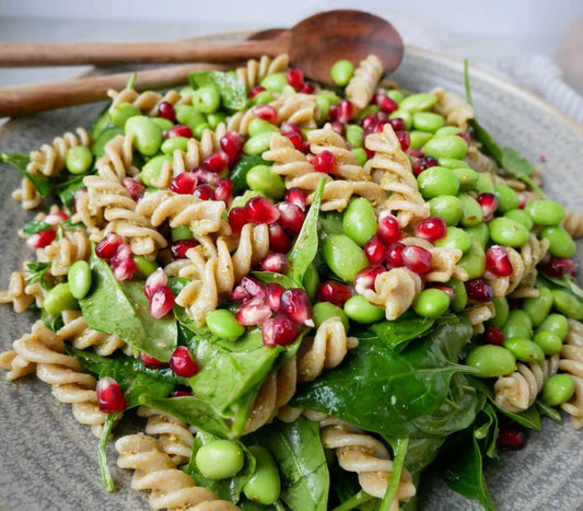 Easy pasta salad with pomegranate, spinach, and pesto for healthy meal prep