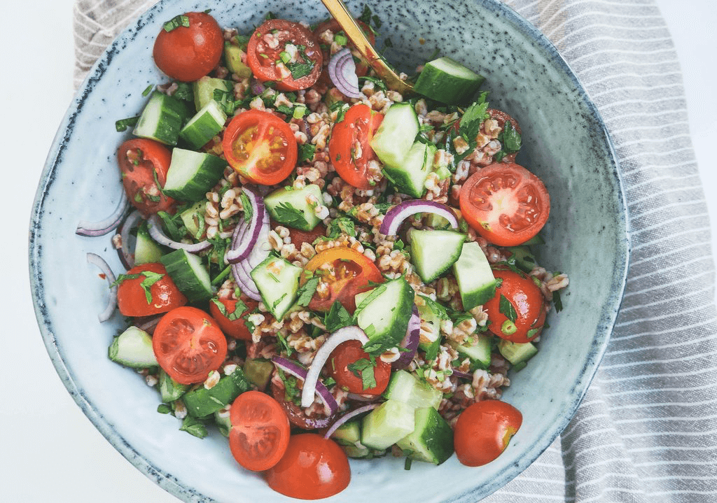 healthy middle eastern salad with lots of green vegetables, pearl spelt, and olive oil. An amazing side dish that goes great with chicken, tenderloin, lamb, and more